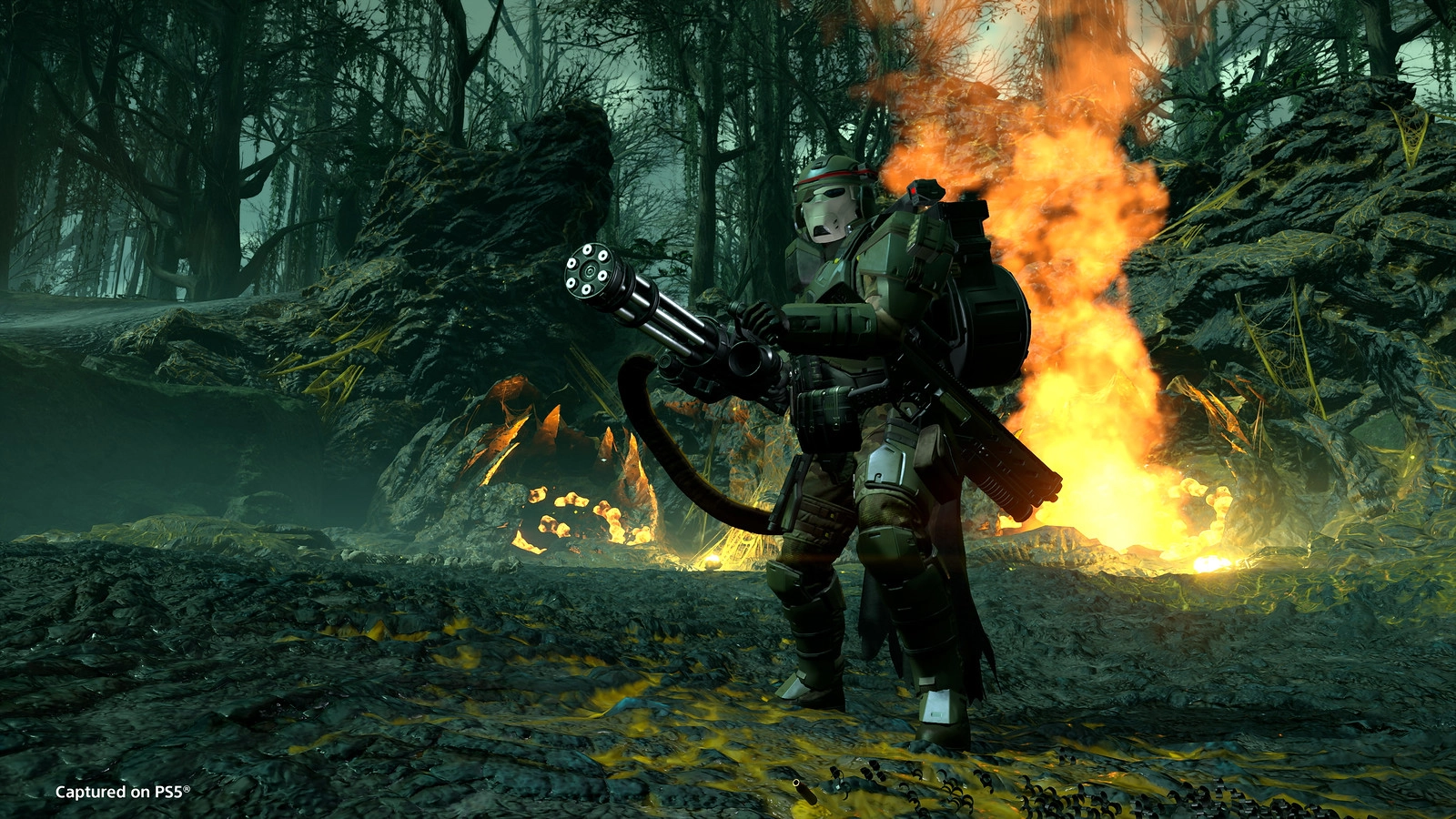 Helldivers warrior with M-1000 Maxigun amidst fiery landscape, showcasing new weapons from the Python Commandos Warbond.