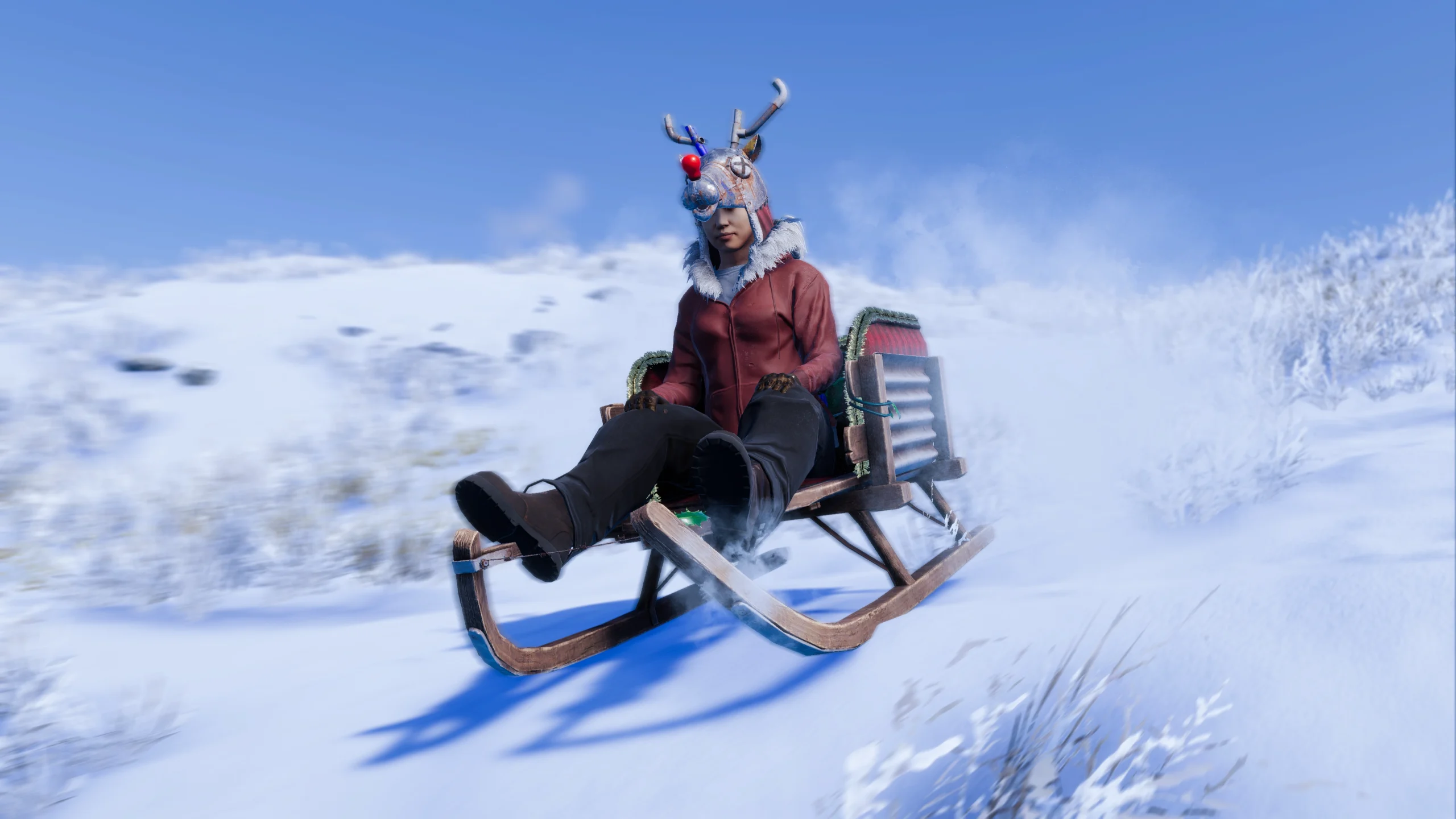 A player in festive gear slides down a snowy hill on a sled, showcasing winter fun in Rust Console Edition