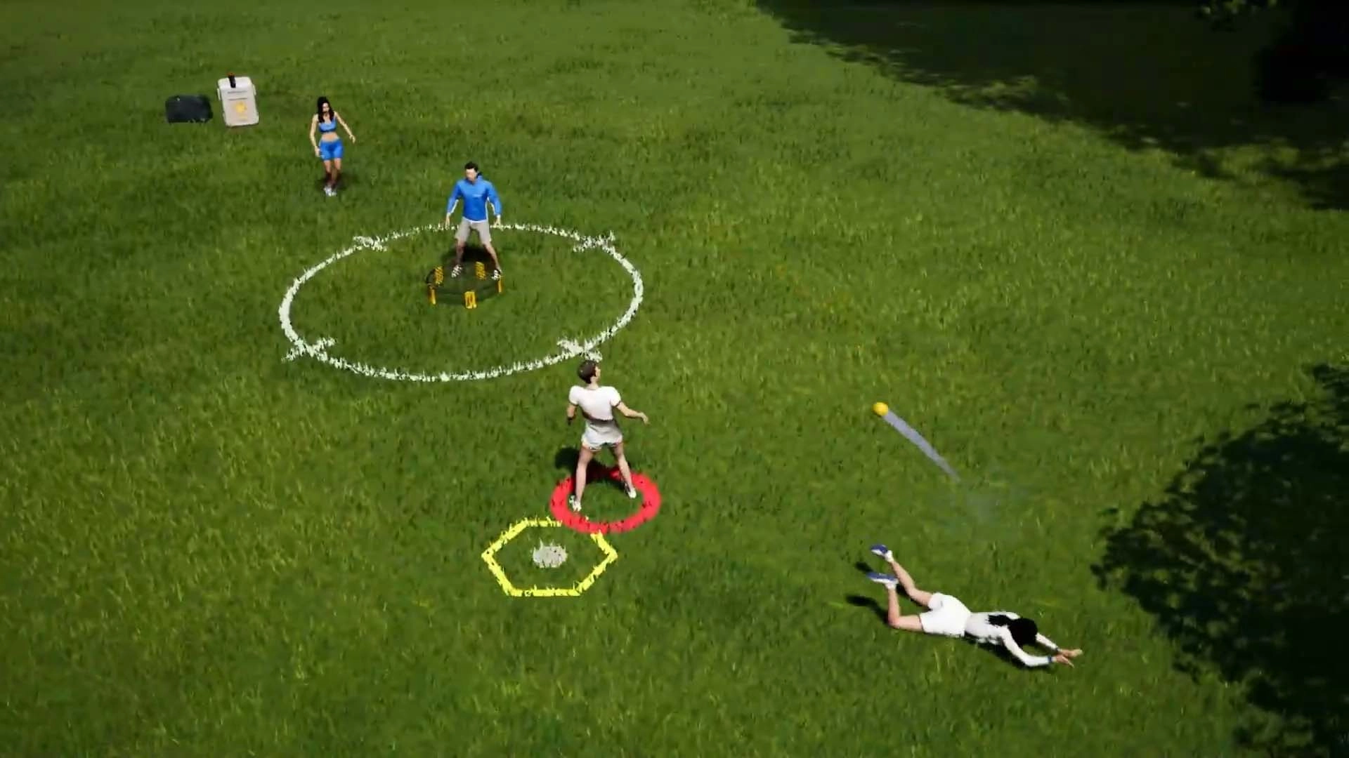 Four players compete in a lively game of Spikeball on grass, highlighting the sport