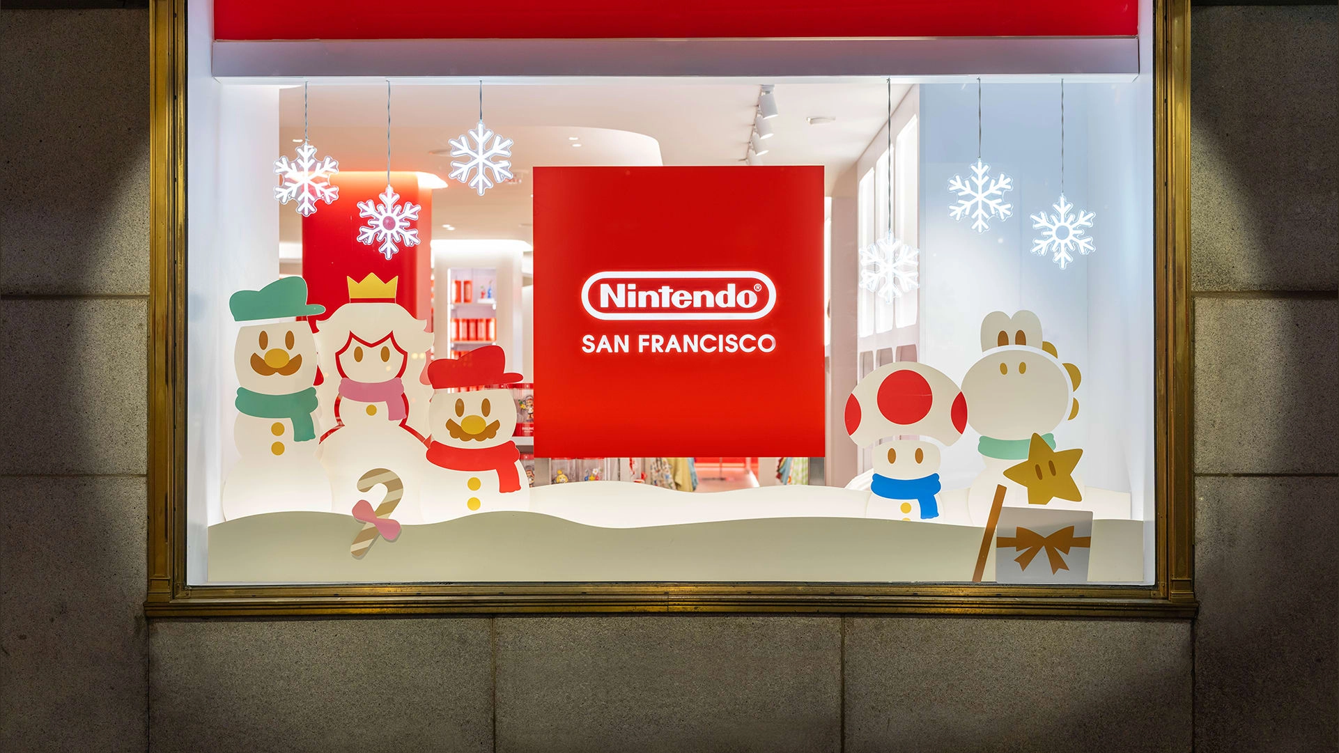 Festive Nintendo San Francisco window display with holiday characters and decorations, showcasing exclusive winter merchan...