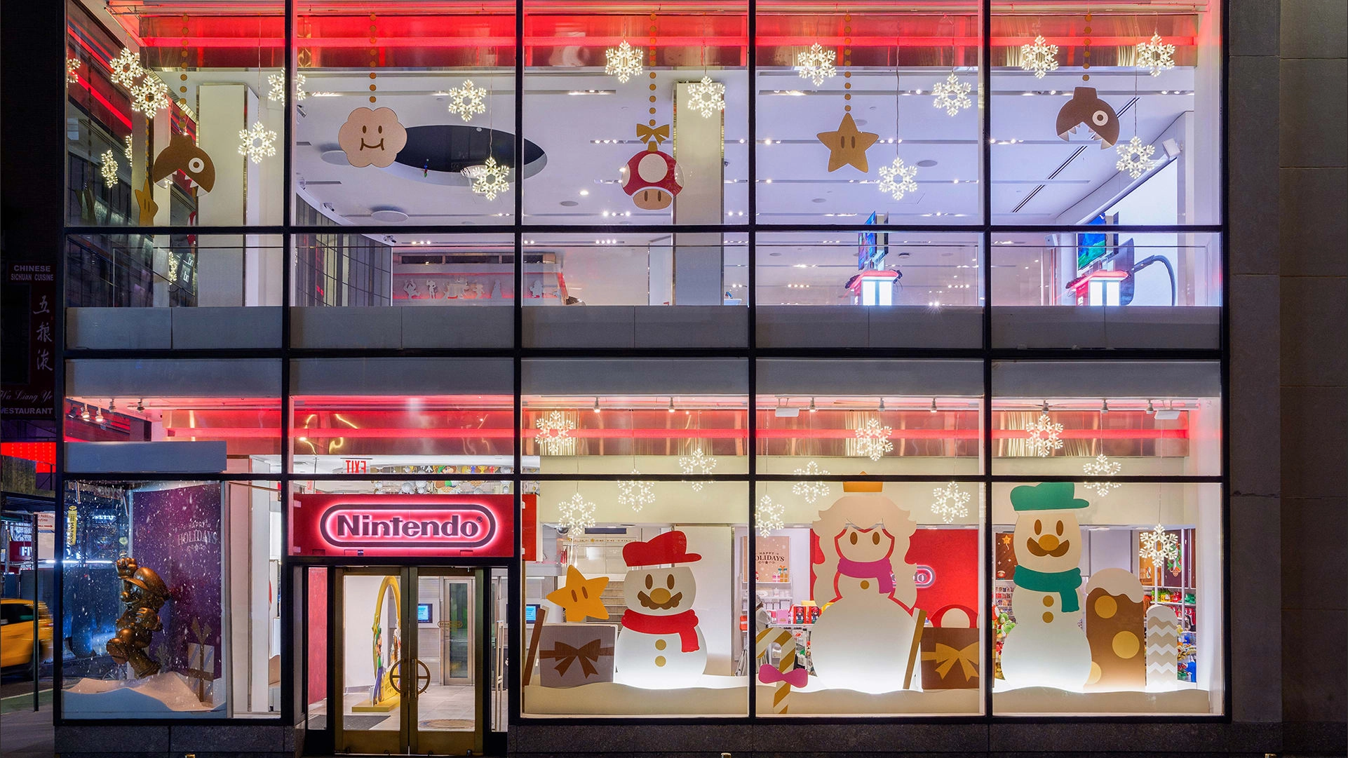 Festive holiday window display at Nintendo stores in San Francisco and New York, featuring cheerful decorations and season...