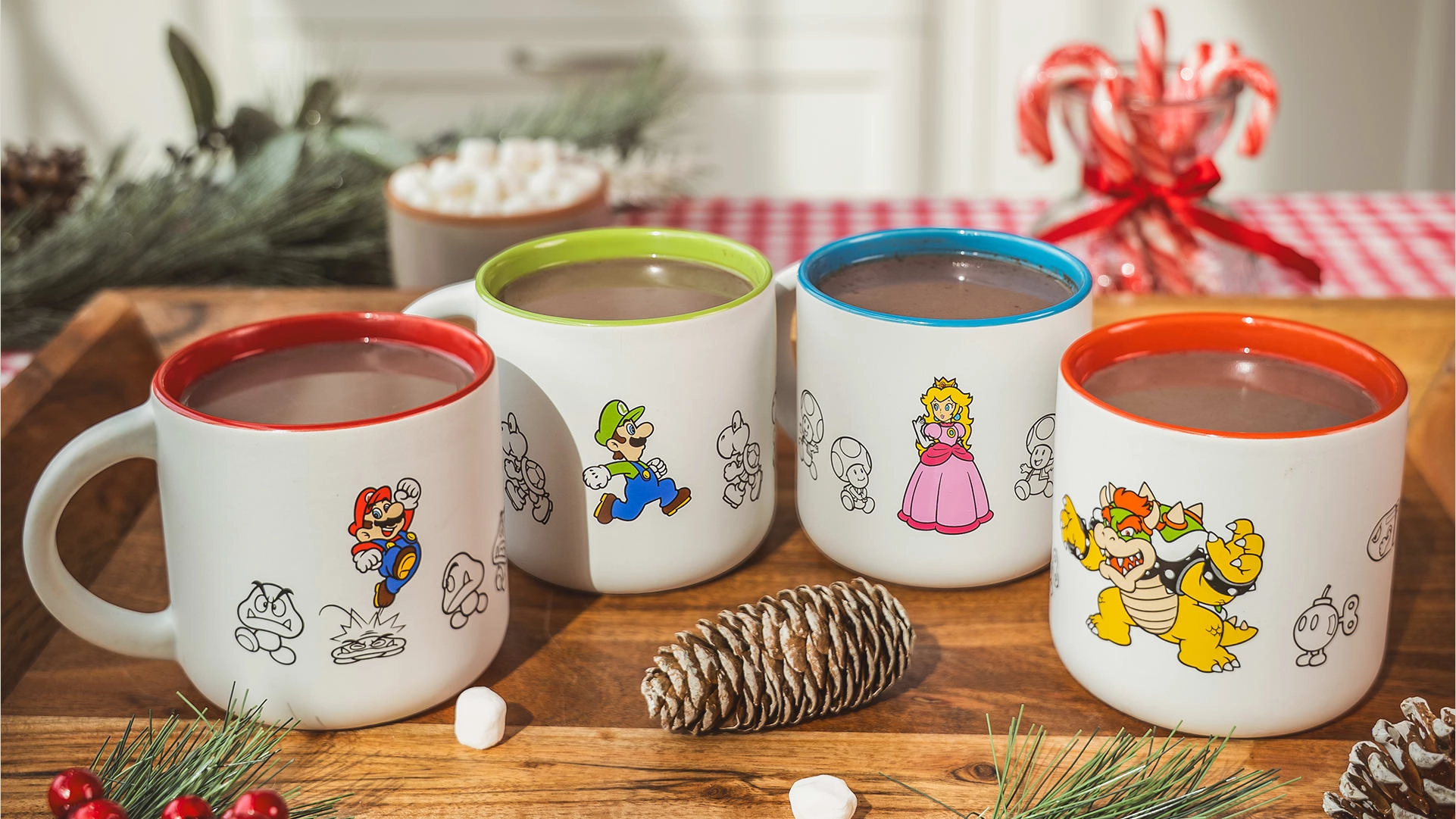 Cozy Nintendo holiday mugs featuring Mario, Luigi, Peach, and Bowser, perfect for seasonal hot cocoa delights.