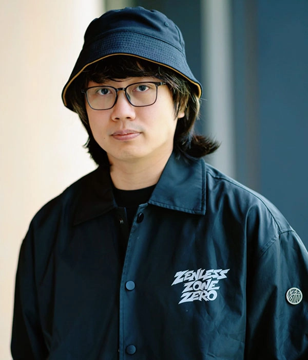 Man in glasses and bucket hat wearing a black Zealess Zone Zero jacket, featured at the PlayStation Partner Awards.
