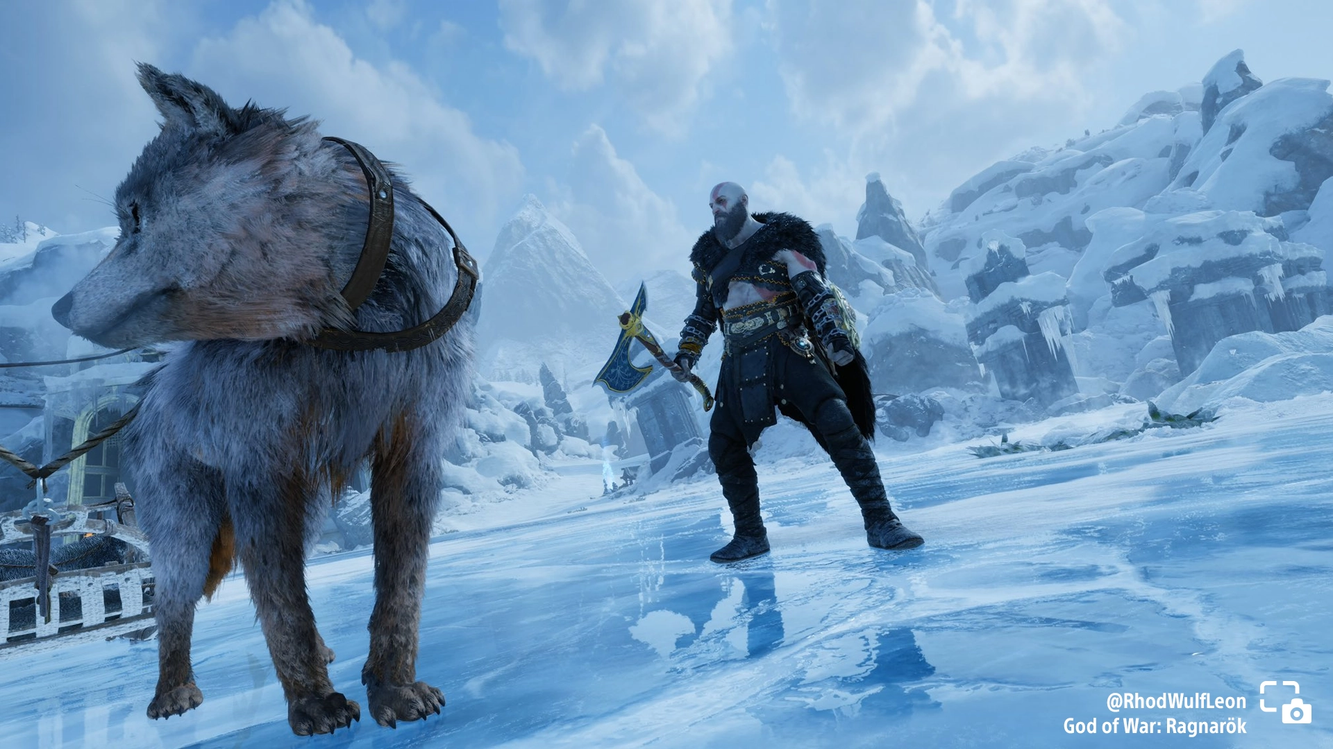 Kratos stands on icy terrain with a wolf in God of War Ragnarök, highlighted amidst a stunning snowy landscape. #PSshare #...