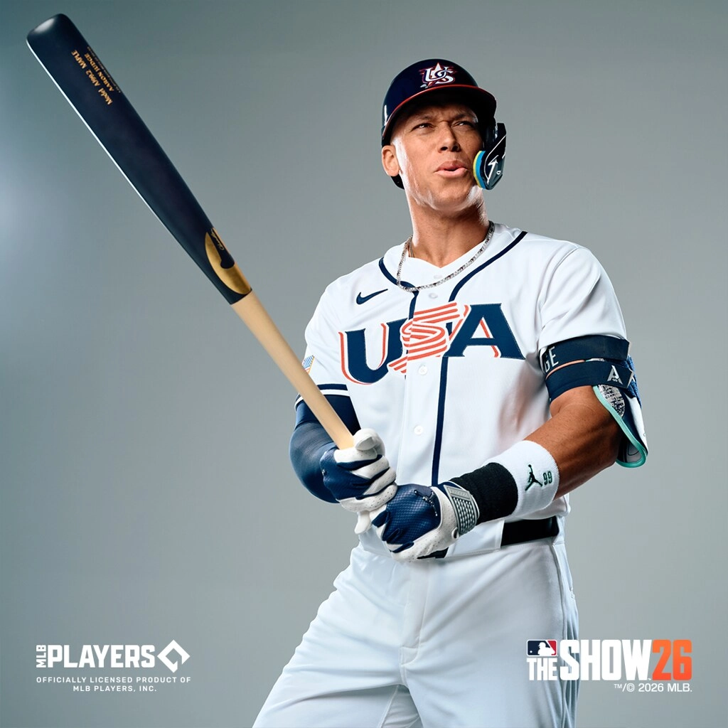 Baseball player in USA uniform holding a bat, promoting MLB The Show 26 game release