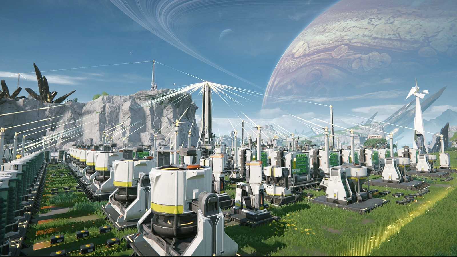 Futuristic industrial landscape with advanced machinery and wind turbines under a vast alien sky on Talos-II