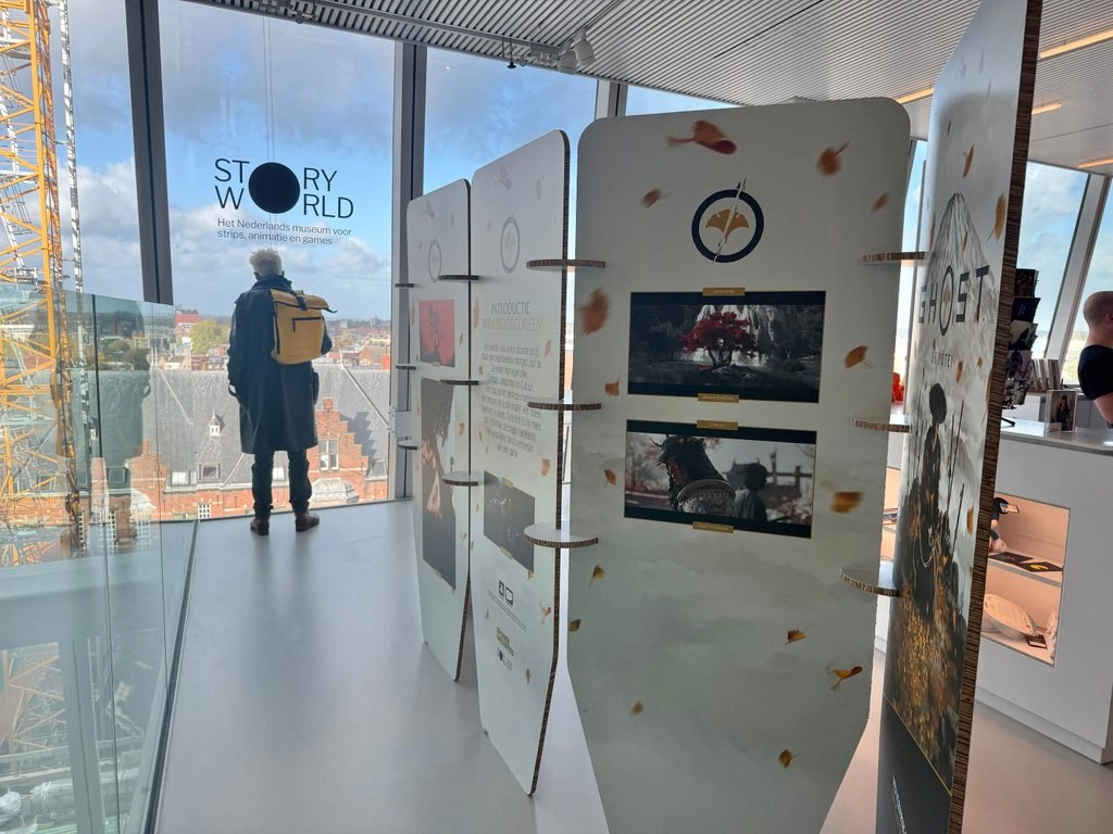 Exhibit showcasing Ghost of Yōtei game art and promotional materials at a modern gallery space