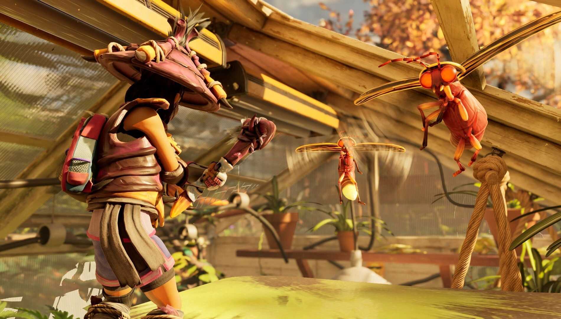 A character in armor battles flying insects inside a greenhouse, surrounded by plants and sunlight