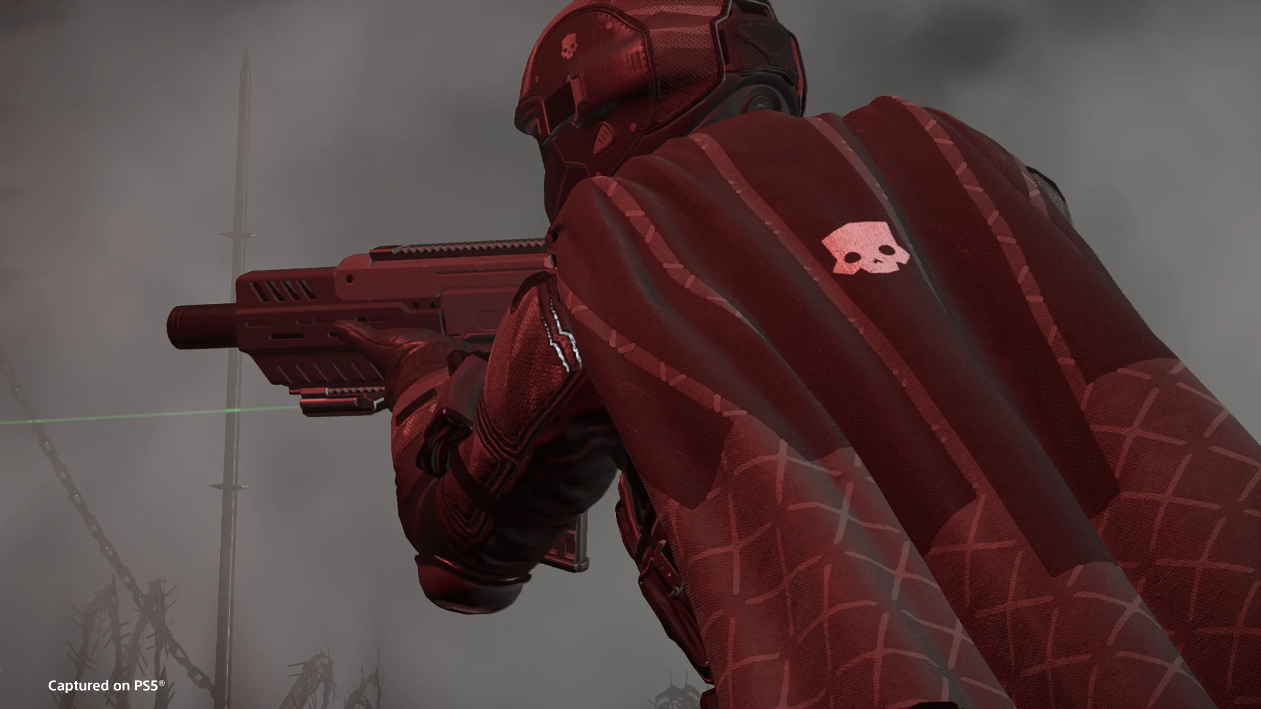Futuristic soldier in red armor aiming futuristic weapon in dark, smoke-filled environment.