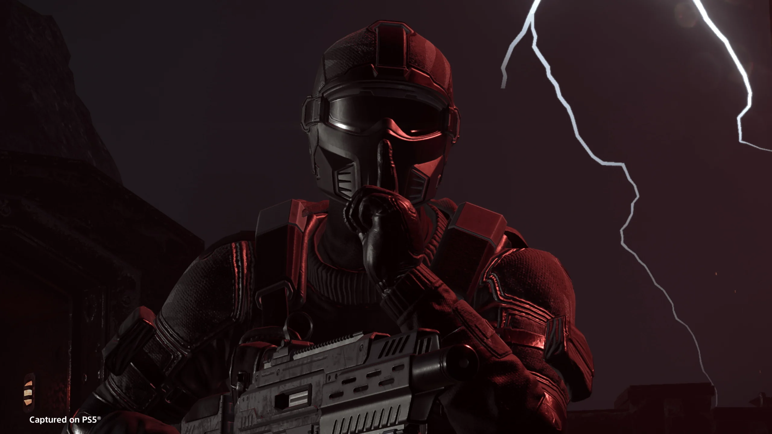 Black-armored soldier with finger to lips in a stealth pose, holding a futuristic rifle, against a backdrop of lightning.