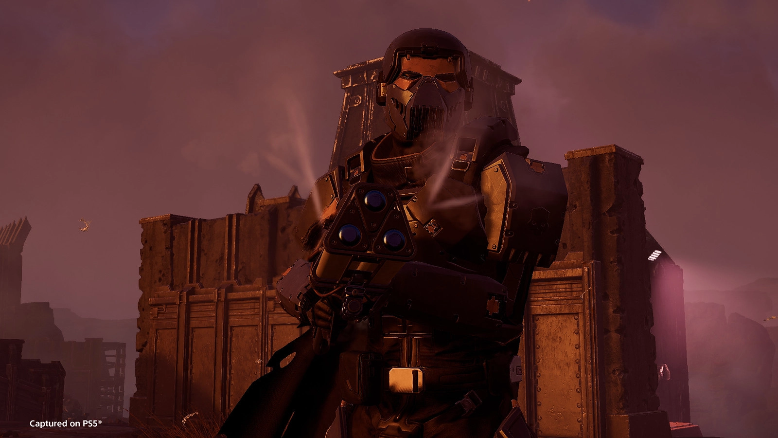 A heavily armored soldier stands ready with a futuristic weapon amidst a fortified battlefield backdrop