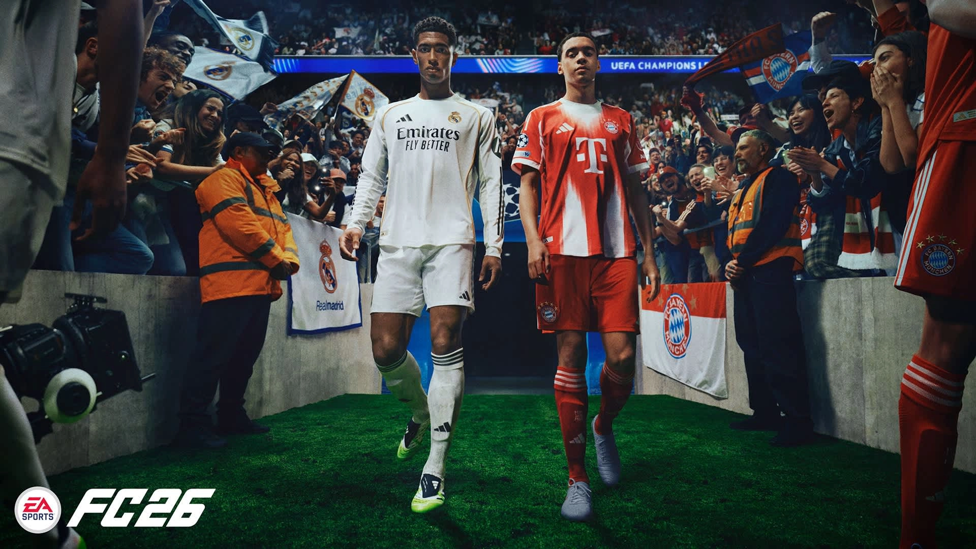 Two soccer players in white and red kits walk onto a stadium field, surrounded by cheering fans
