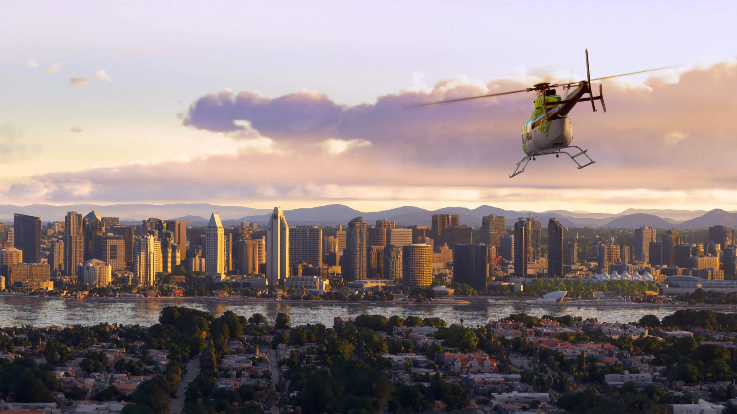 Helicopter flying over a vibrant California cityscape at sunset, showcasing urban and natural beauty