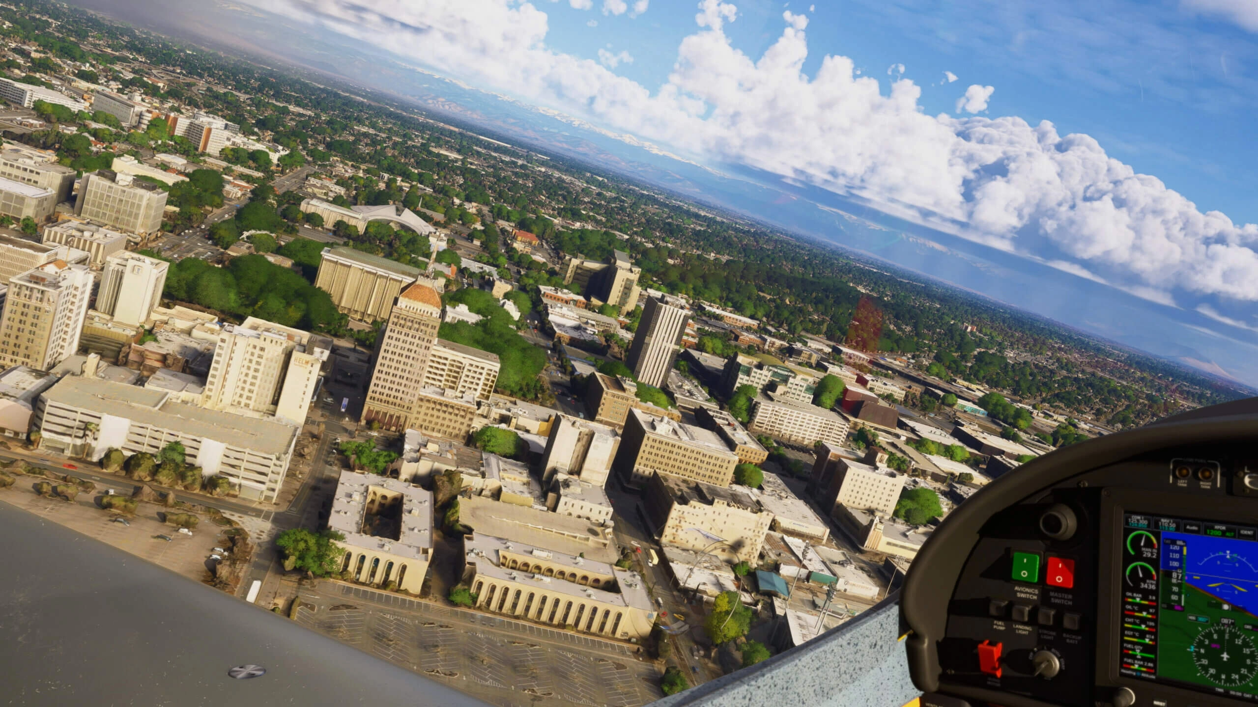 Aerial view of Sacramento's downtown with iconic buildings and lush greenery under a partly cloudy sky