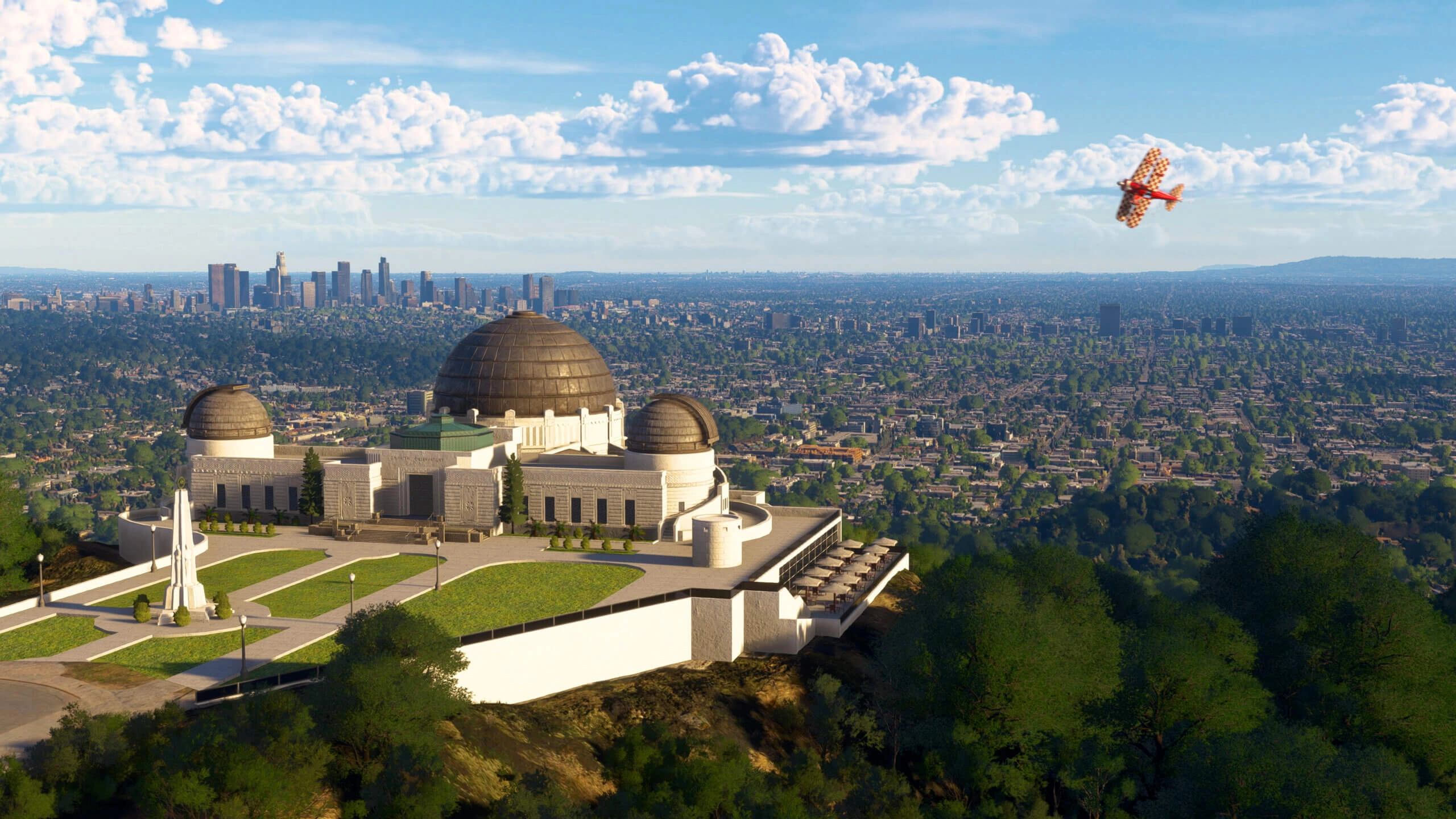 Griffith Observatory overlooking Los Angeles cityscape with a plane flying above in Microsoft Flight Simulator