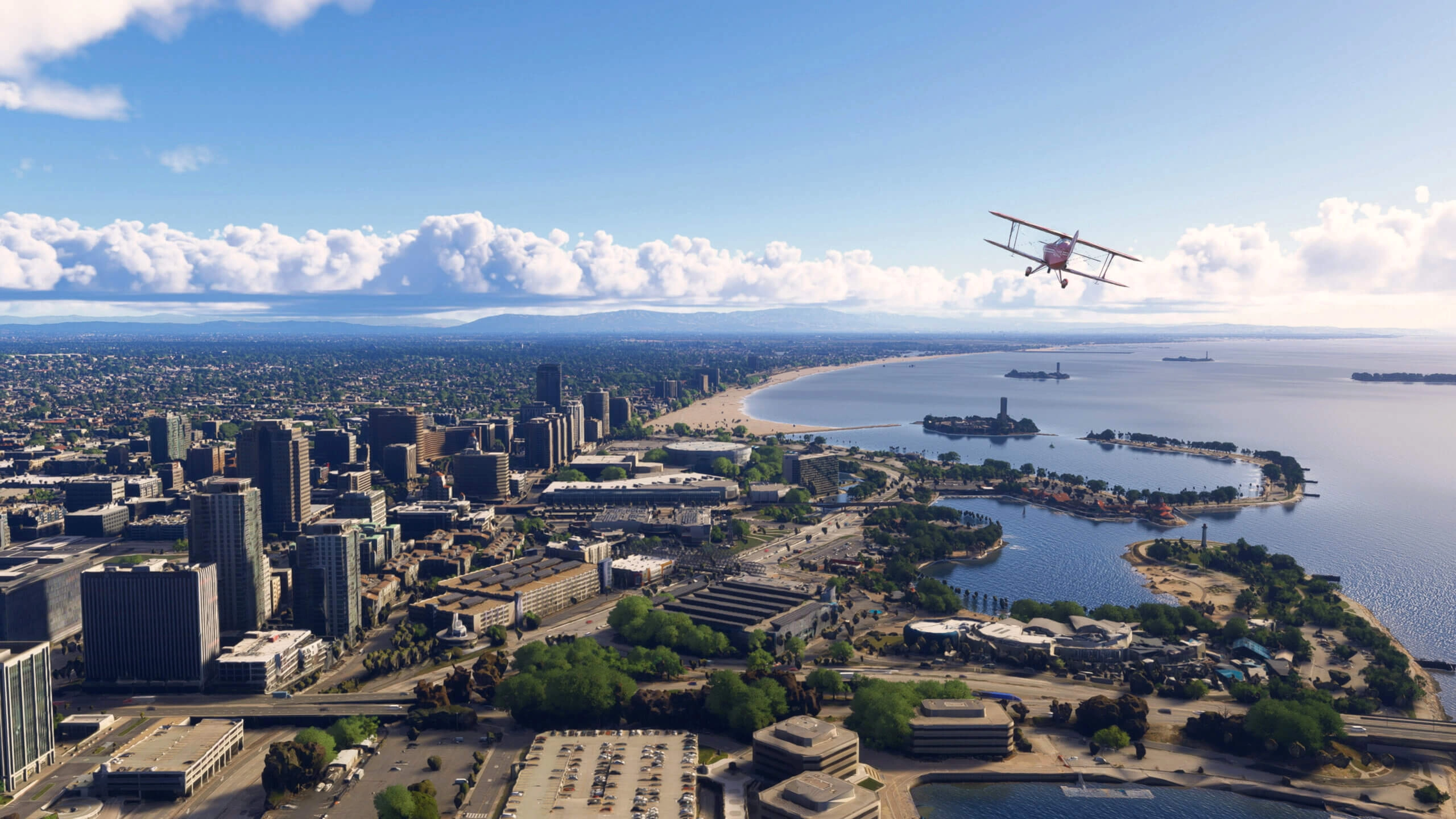 Aerial view of a coastal California cityscape with a plane flying over, showcasing urban and natural beauty