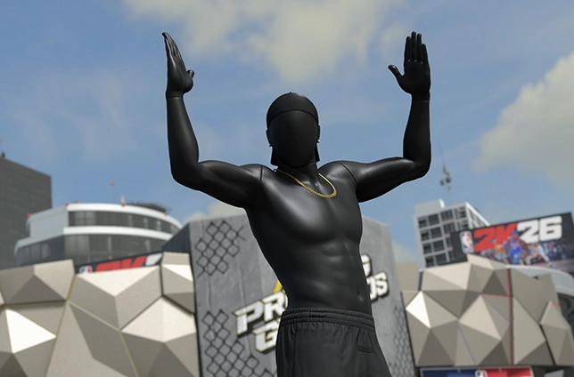Basketball player statue with raised arms in front of NBA 2K26 promotional backdrop under cloudy sky