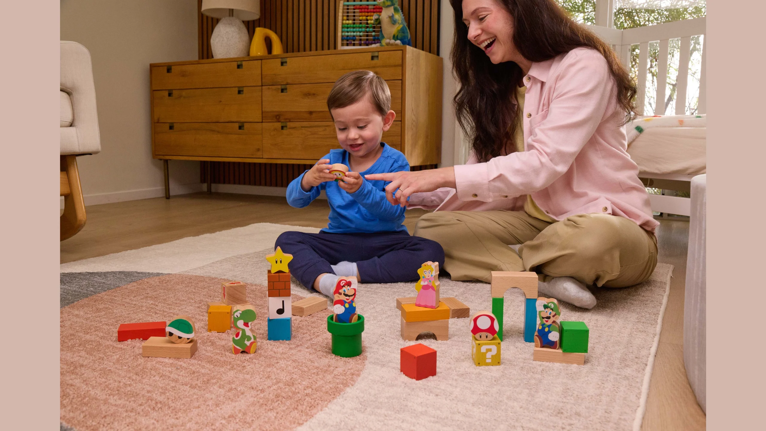 Mom and child play with colorful My Mario blocks, exploring creativity and fun with iconic characters in a cozy setting.