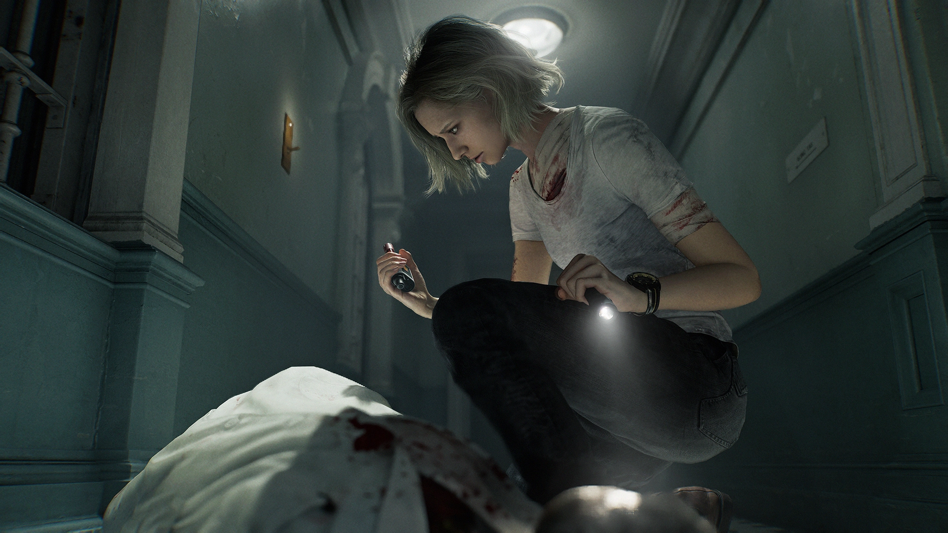 A woman with a flashlight examines a bloodied figure in a dimly lit hallway, creating a tense atmosphere