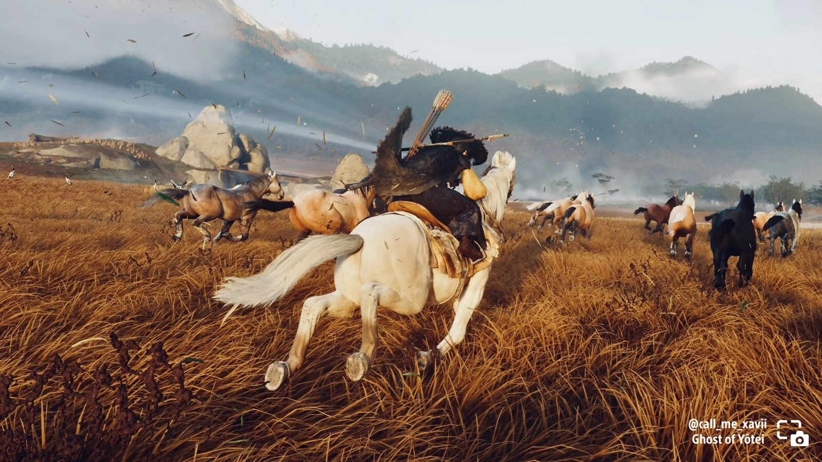 A rider on a white horse gallops through a field alongside a herd of wild horses in Ghost of Yōtei