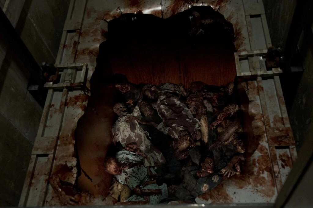 A pile of decaying zombie bodies in a dark, grim setting, evoking the horror of a post-apocalyptic world
