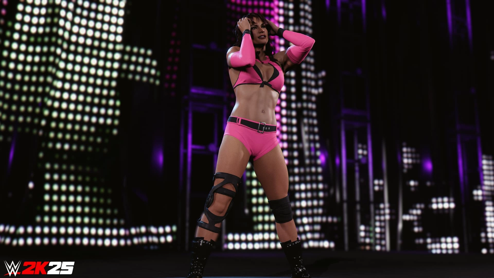 Wrestler in pink attire poses confidently on stage with vibrant lights in WWE 2K25 game setting