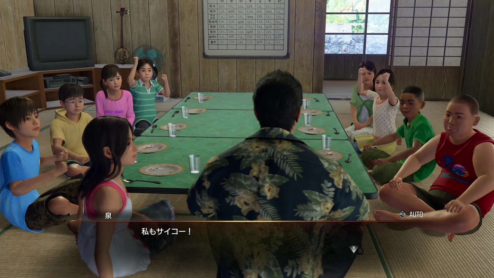 A group of children and an adult sit around a table in a traditional Japanese room, engaging in conversation
