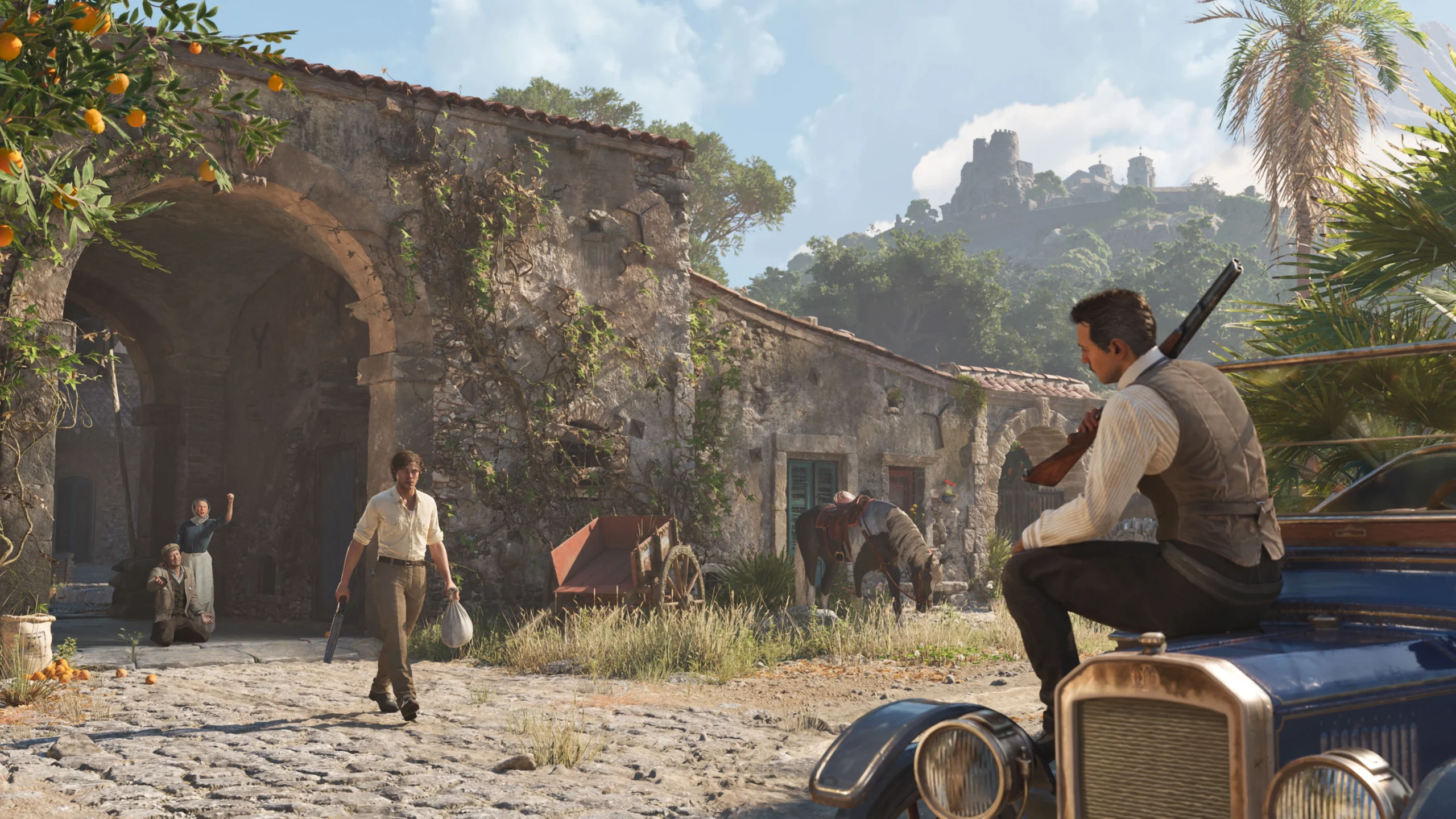 A man with a rifle sits on a vintage car in a rustic Sicilian village, another man approaches holding a bag