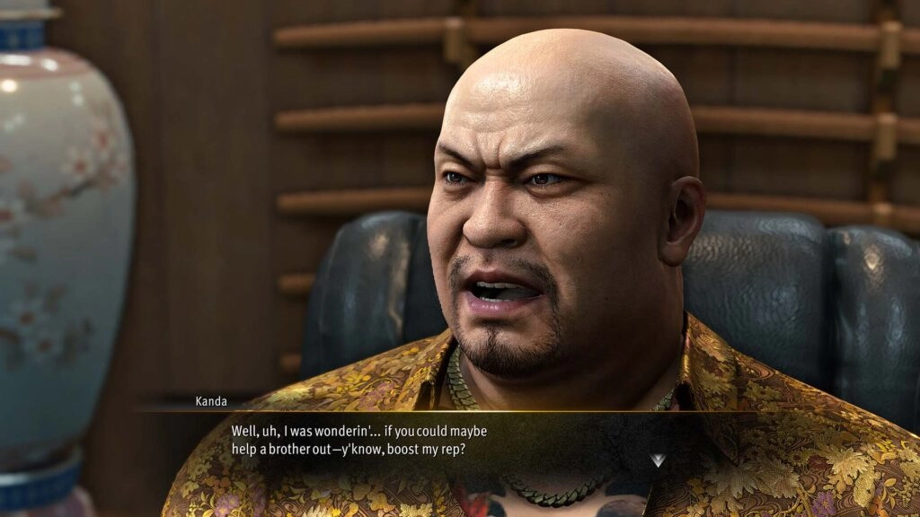 Kanda, a character from Yakuza Kiwami 3, sits in an office, speaking about boosting his reputation
