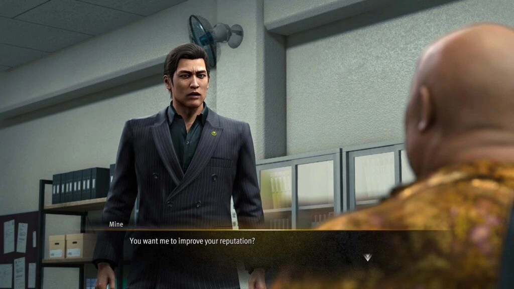 Mine stands in an office, speaking to a seated man, discussing reputation improvement strategies