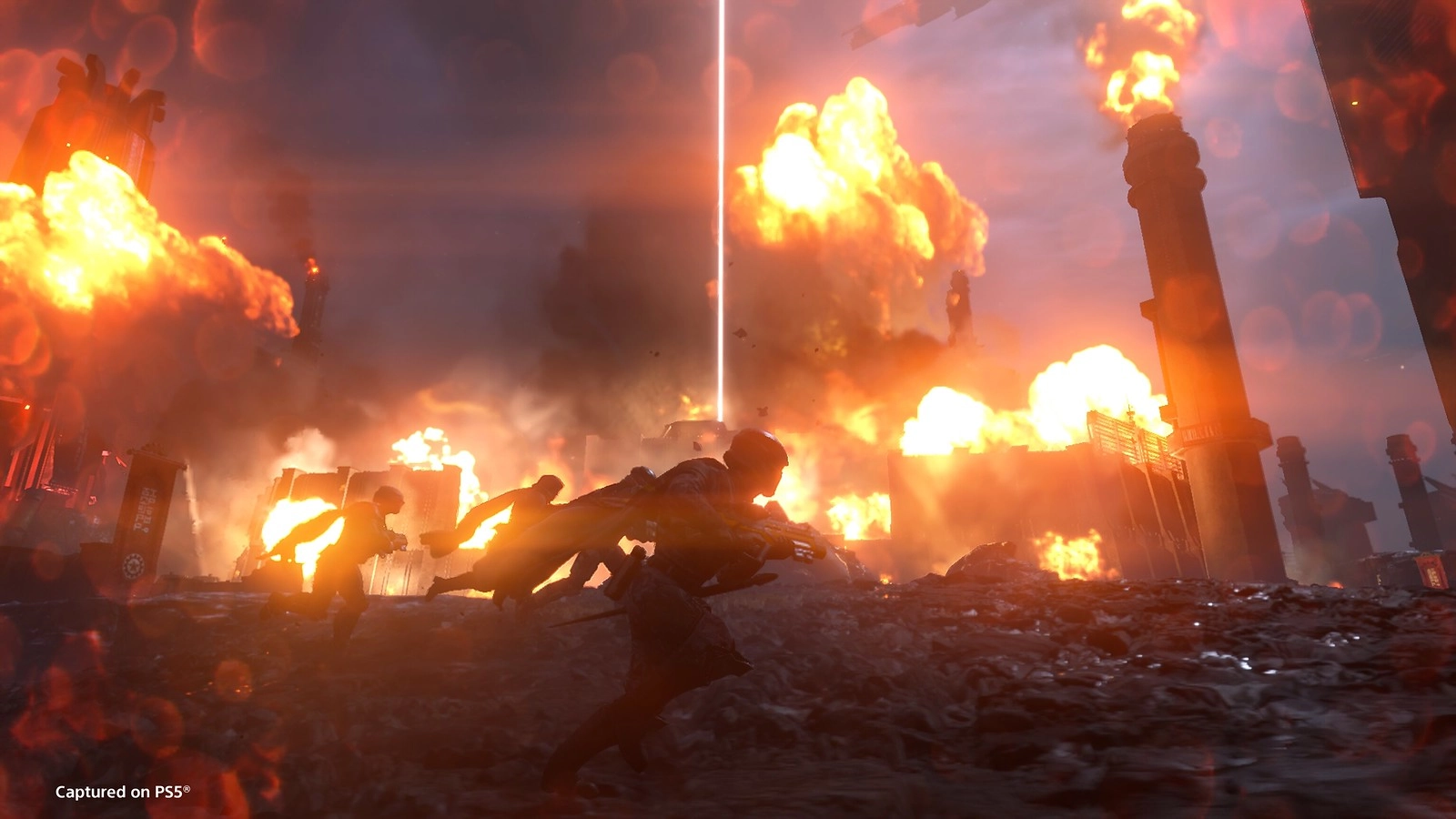 Helldivers battling through fiery explosions in Cyberstan's industrial landscape, fighting against Cyborg threats