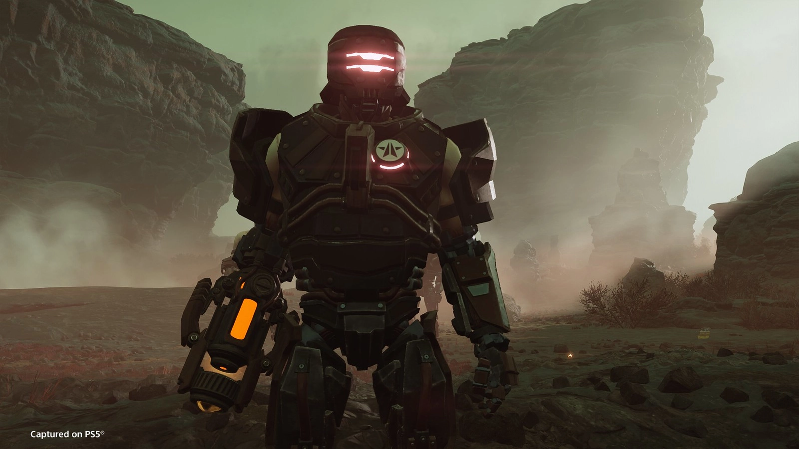 A towering cyborg stands in a desolate, rocky landscape of Cyberstan, ready for battle against Helldivers