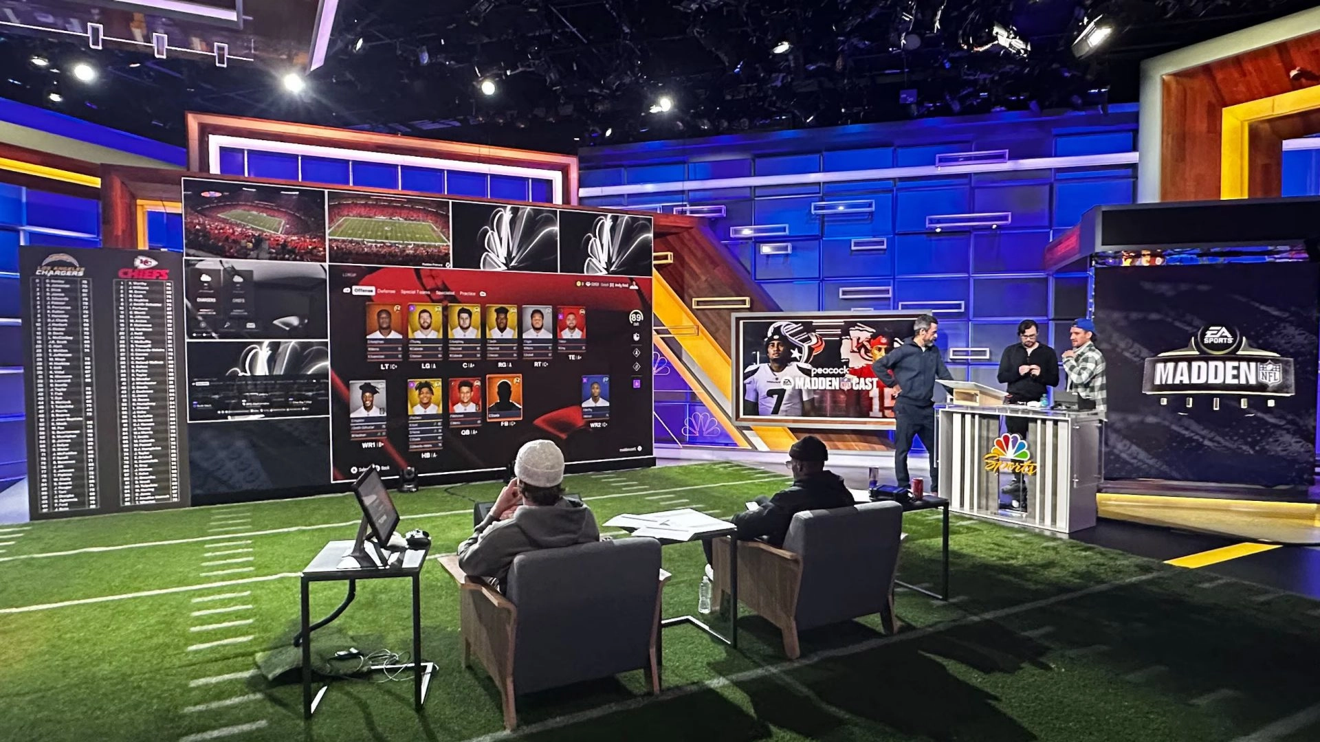 Studio setup with analysts discussing Madden NFL, large screens displaying game stats and player profiles